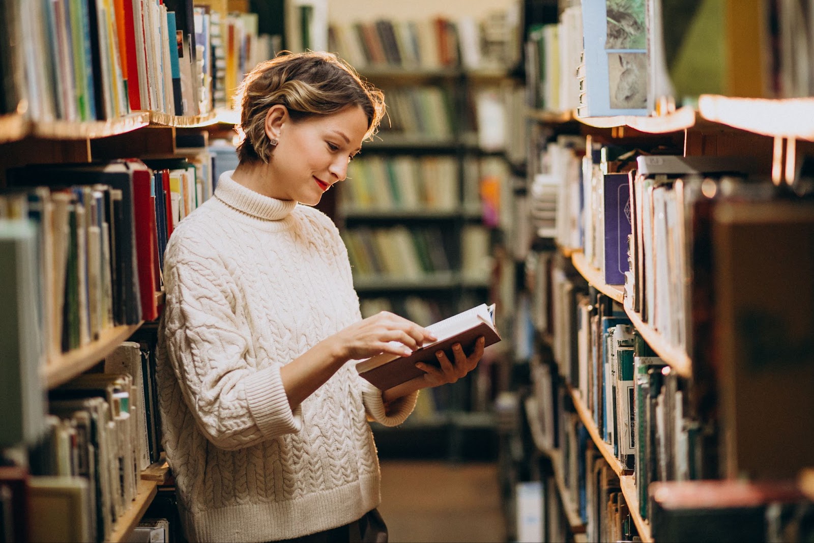 A woman reading a book in the library