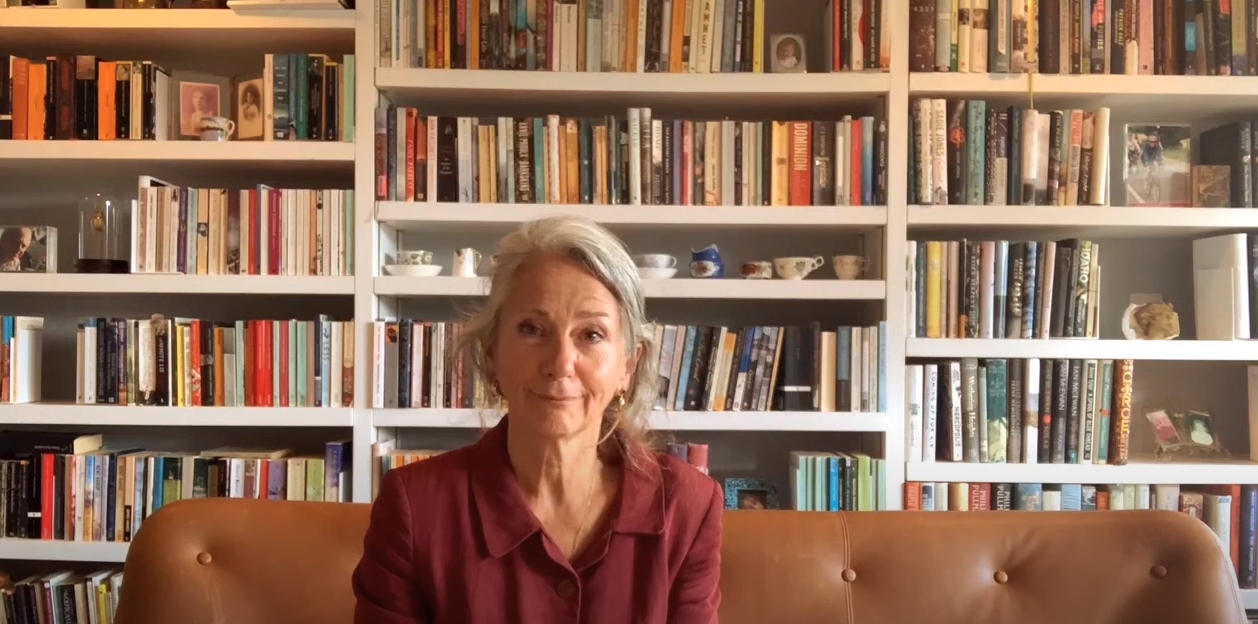 An image of Rachel Joyce with bookshelves filled with books on the background